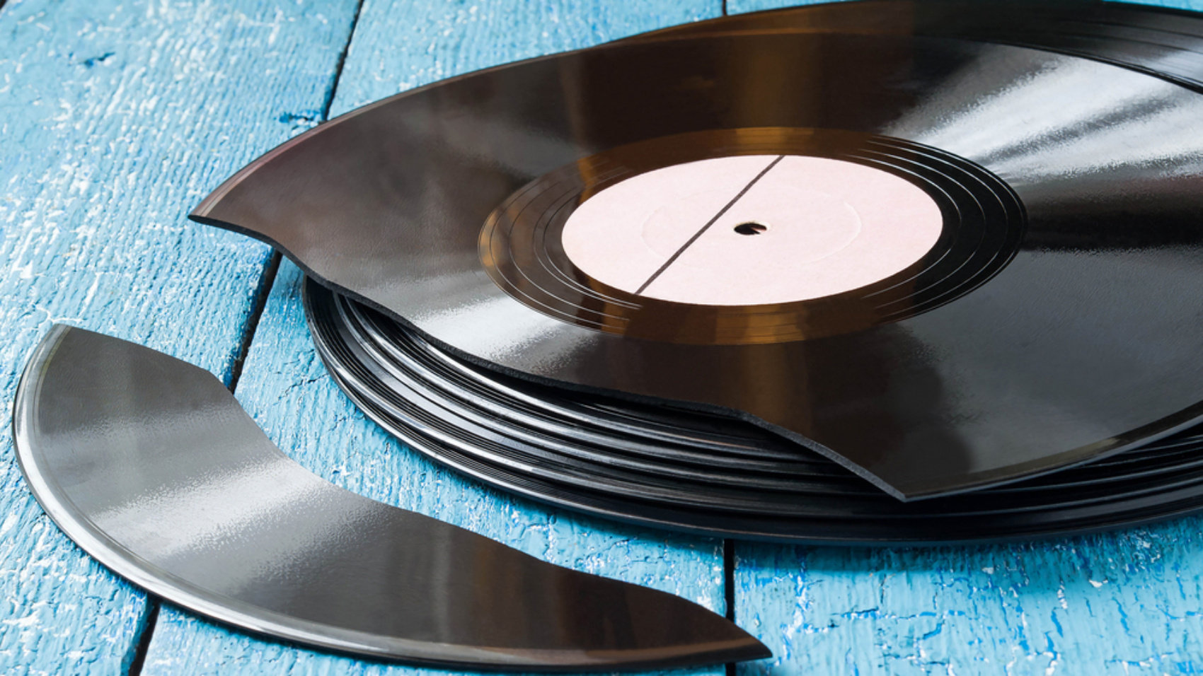 Stack,Of,Old,Vinyl,Records,On,A,Blue,Wooden,Background,
