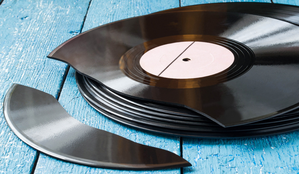 Stack,Of,Old,Vinyl,Records,On,A,Blue,Wooden,Background,