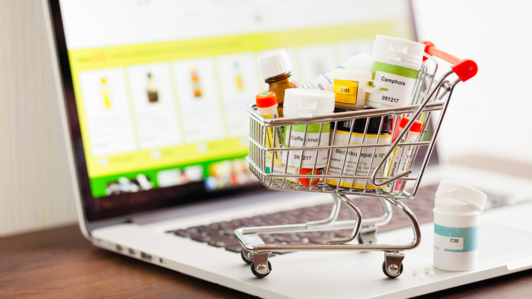 Mini,Shopping,Cart,Full,Of,Homeopathic,Remedies,On,Laptop,Background.