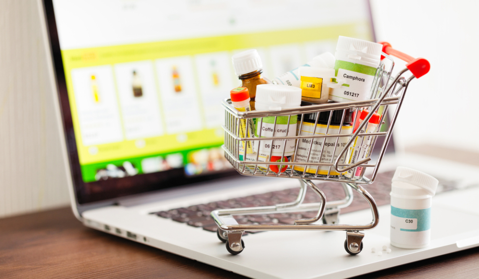 Mini,Shopping,Cart,Full,Of,Homeopathic,Remedies,On,Laptop,Background.